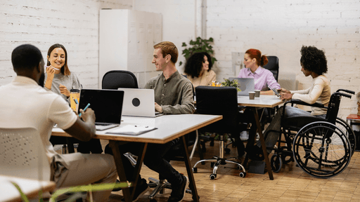 A diverse team meeting around a conference table to plan AI for ROI&trade; work